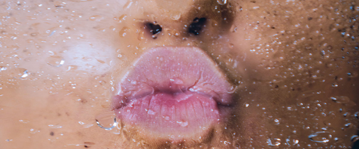 lips kissing wet glass